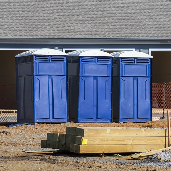 what is the cost difference between standard and deluxe portable restroom rentals in Clinton